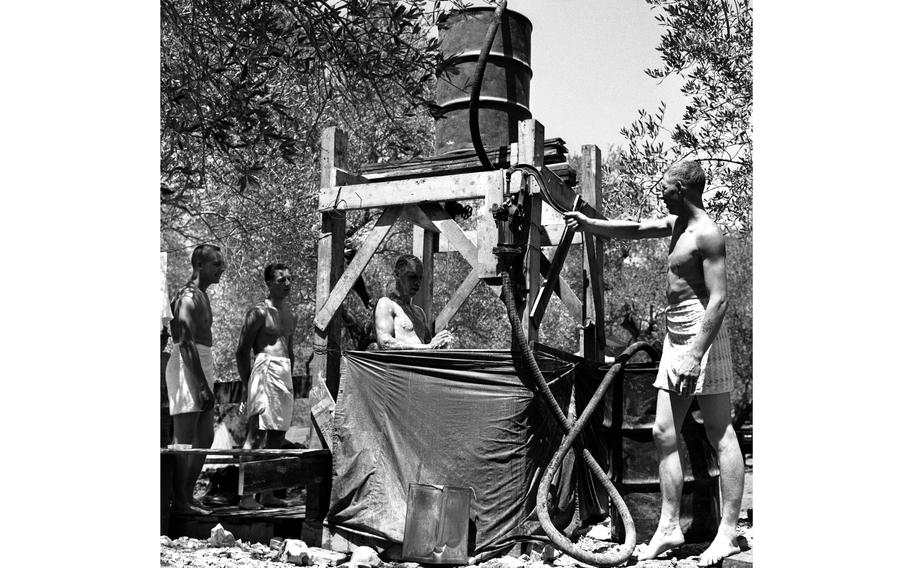 Soldiers in Lebanon use a makeshift shower