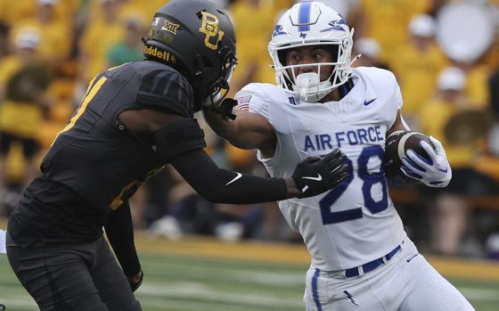 Air Force running back Aiden Calvert stiff-arms Baylor linebacker Keaton Thomas while running toward the sidelines during the first half of an NCAA college football game, Saturday, Sept. 14, 2024, in Waco, Texas. (Rod Aydelotte/Waco Tribune-Herald via AP)