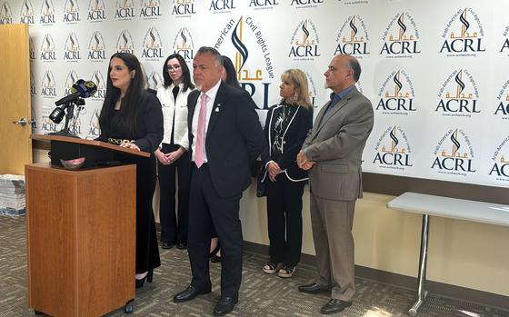 Arab-American Civil Rights League founder and chairman Nabih Ayad, front right, stands next to Executive Director Mariam Charara, at the podium in Dearborn, Michigan, on Thursday, Oct. 3, 2024. The nonprofit sued the U.S.'s top state and defense officials to compel faster evacuation of U.S. residents from Lebanon. (Julia Cardi/The Detroit News/TNS)