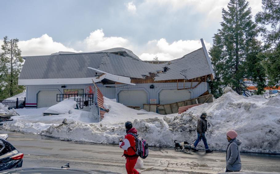 A business with a caved-in roof following heavy snowfall in Crestline, Calif., on March 7, 2023. 