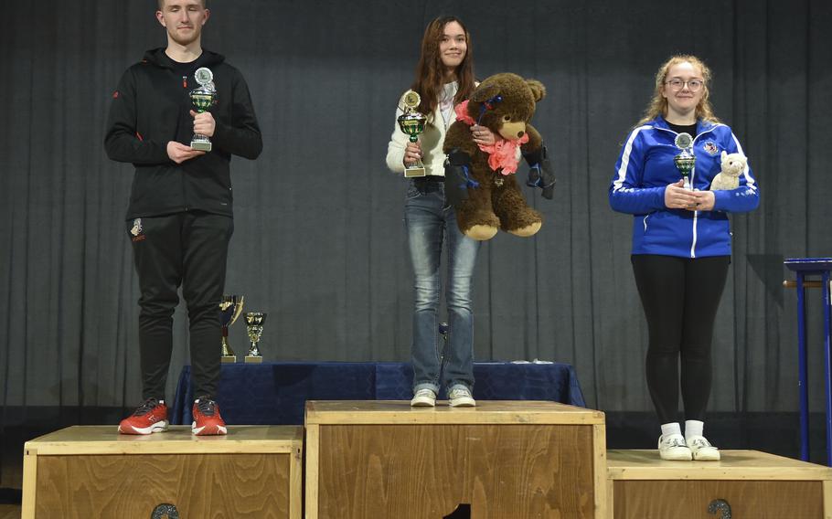 The top three stand on the podium.