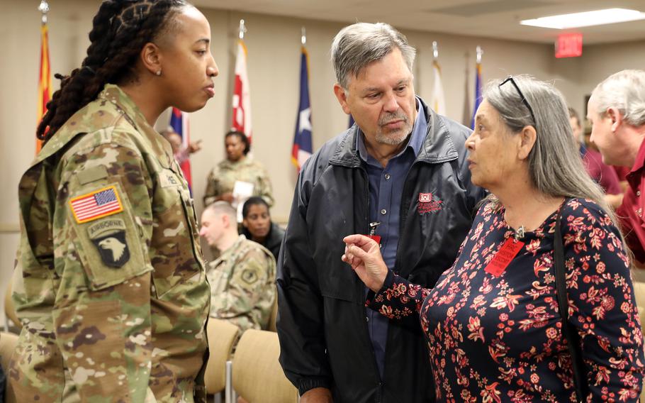 Army Staff Sgt. Aschlynd Spidell-Flores, left, and Luke Cooper, Dianna McMahan’s brother, listen as McMahan describes her recovery from injuries in a car crash last year. Spidell-Flores was awarded the Soldier's Medal on Oct. 20, 2023, for saving McMahan's life.