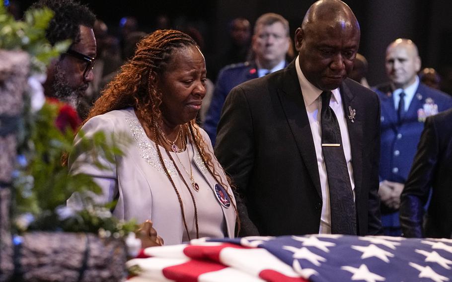 Chantemekki Fortson, left, the mother of slain airman Roger Fortson and Trial lawyer Benjamin Crump stand at his casket during his funeral at New Birth Missionary Baptist Church, Friday, May 17, 2024, near Atlanta. 
