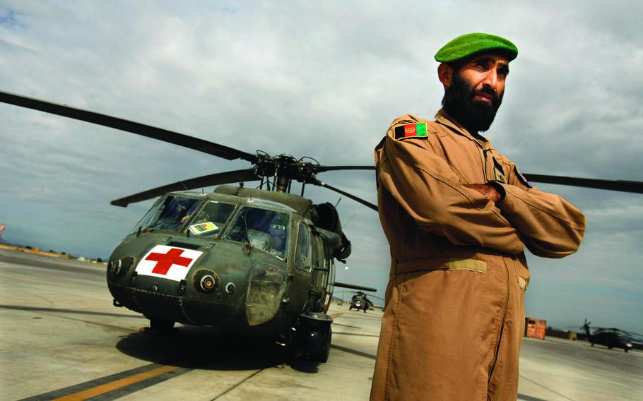 Sgt. Gulap Ahmadzia pauses near a U.S. medevac helicopter