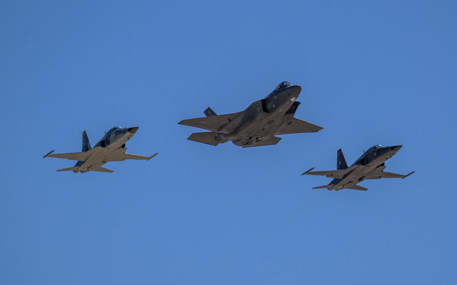 Blue sky above as the aircraft fly in formation.