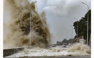 In this photo released by Xinhua News Agency, huge waves lash the shore ahead of landfall by Typhoon Gaemi in Sansha Township of Xiapu County, southeast China's Fujian Province, Thursday July 25, 2024. After hitting Philippines and Taiwan, the storm's effects were expected to continue into Friday as it moved in a northwestern direction toward mainland China. In Fujian province on China's east coast, ferry routes were suspended on Wednesday and all train service will be halted on Thursday, China's official Xinhua News Agency said. (Jiang Kehong/Xinhua via AP)