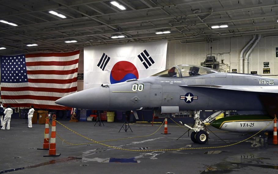 An F-18 fighter jet sits in the hanger of the USS Theodore Roosevelt aircraft carrier while anchored at Busan Naval Base in Busan, South Korea, on June 22, 2024.