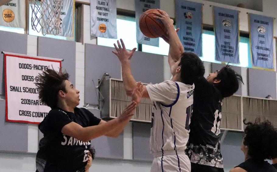 Ben Ziegler and Luis Mendoza battle for a rebound.