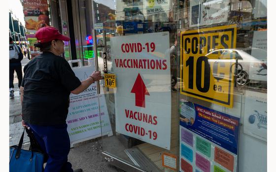 A pharmacy advertises COVID-19 vaccines in a window along Roosevelt Avenue, which passes through the neighborhoods of Elmhurst, Corona and Jackson Heights, areas that witnessed some of the highest numbers of COVID-19 cases and deaths on May 11, 2023, in the Queens borough of New York City. (Spencer Platt/Getty Images/TNS)