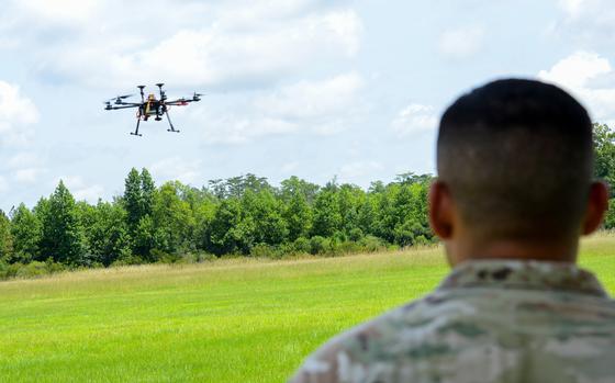 A 3rd Infantry Division soldier watches as a small drone built in a drone-building class at Fort Stewart, Ga., flies over a small airfield just off the Army post on July 26, 2024. (Corey Dickstein/Stars and Stripes)