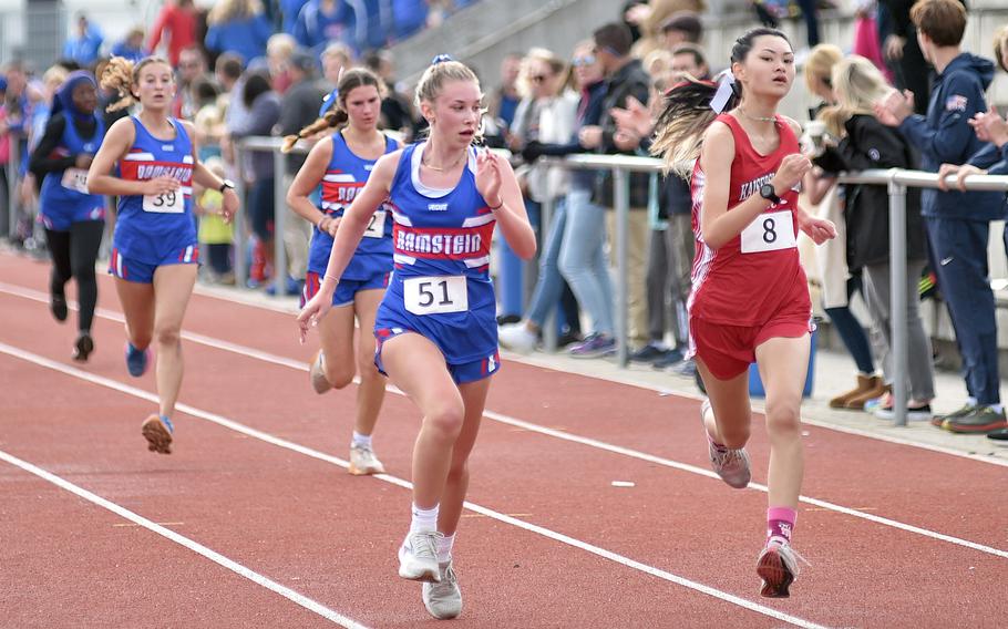 Ramstein's Olivia Loringer looks to her left as Kaiserslautern's Ashley Kosterman tries to pass her during a cross country meet on Sept. 14, 2024, at Ramstein High School on Ramstein Air Base, Germany.