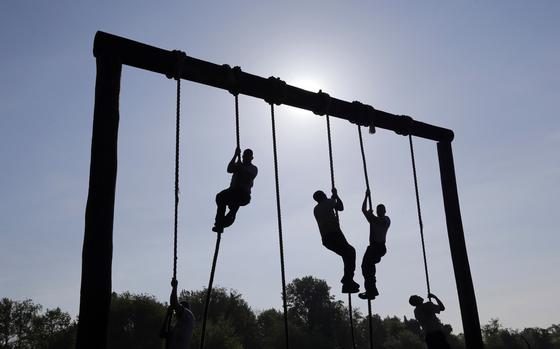 FILE - Freshman midshipmen, known as plebes, climb ropes on an obstacle course during Sea Trials, a day of physical and mental challenges that caps off the freshman year at the U.S. Naval Academy in Annapolis, Md., May 13, 2014. (AP Photo/Patrick Semansky, File)