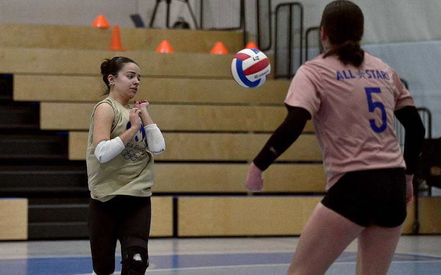 Kaiserslautern libero Marisa Branch of the Pink team lets a ball go by as teammate Sophie Fedorisin watches during the 2024 DODEA-Europe All-Star volleyball matches on Nov. 9, 2024, at Ramstein High School on Ramstein Air Base, Germany.