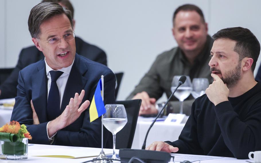 NATO Secretary General Mark Rutte, left, speaks with Ukraine’s President Volodymyr Zelenskyy during the NATO-Ukraine Council working dinner at NATO Headquarters in Brussels.