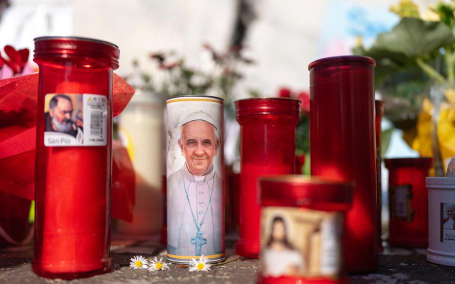 Candles left outside the Agostino Gemelli Polyclinic, in Rome.