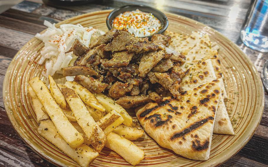 Pork gyro meal on a plate at Little Greece restaurant.