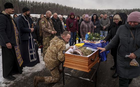 FILE - During a funeral ceremony in Irpin, the Kyiv region of Ukraine, on Nov. 21, serviceman Roman bids farewell to a comrade from the 47th Brigade -- Serhii Solovyov -- who was killed during fighting with Russian Forces in Kursk on November 12, 2024. (AP Photo/Evgeniy Maloletka, File)