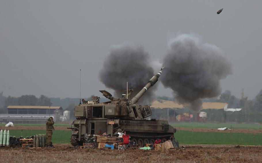 An Israeli army tank shells the Gaza Strip from the border area in southern Israel on Dec. 14, 2023, amid ongoing battles with the Palestinian Hamas movement.