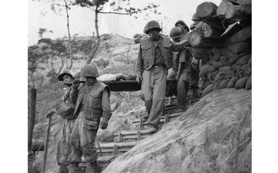 Hill 400, South Korea, June 21, 1952: Men of the Colombian Battalion - most probably 3rd Platoon, Company A of the 1st Colombian Infantry Battalion - and their South Korean Army counterparts carry one of their wounded men down Hill 400 after the conclusion of a successful raid on the hill. 

Lasting only an hour and 30 minutes the Colombians killed 28 enemy soldiers, destroyed its artillery positions and took the hill. The platoon suffered 2 KIA and 15 wounded. 

By the time the Colombian Battalion returned home on October 29, 1954, the Colombians received twenty-five Bronze Stars with Valor, nine Bronze Stars, eighteen Silver Stars, and two Presidential Unit Citations (one from the United States and one from South Korea), as well as the respect and admiration of the U.S. and South Korean men they fought beside. One hundred thirty-one of its servicemembers had died in combat, ten in wartime accidents, two of natural causes and more than 400 were wounded. 

Colombia was the only Latin American country to dispatch troops to Korea during the Korean War - the 1st Colombian Infantry Battalion, which became known as the Colombian Battalion, arrived in country June 15, 1951 and during their deployment were attached to several U.S. Army Infantry Regiments.

Read Stars and Stripes' 1952 story about the Colombian Battalion's assault on Hill "X" here.

https://www.stripes.com/migration/united-effort-aids-colombian-attack-1.557103

META TAGS: Pacific; South Korea; Korean War; combat; Colombia; Colombian Army; 1st Colombian Battalion; army; war; United Nations Command; UNC; UN; wounded; ROK; casualty