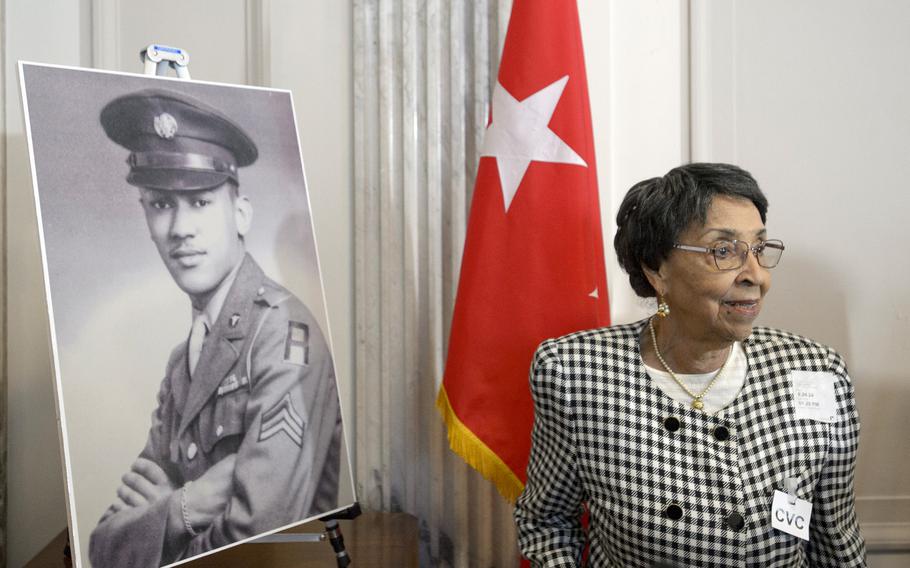 Joann Woodson stands near a portrait of her husband, U.S. Army Staff Sgt. Waverly Woodson Jr., prior to a ceremony to posthumously award him the Distinguished Service Cross in Washington on Sept. 24, 2024.