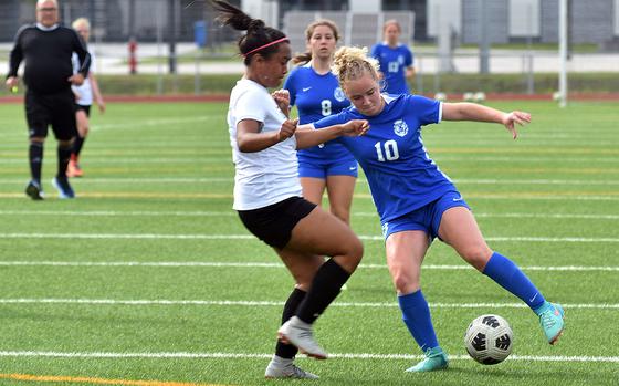 Ramstein's Claire Boynton tries to create some space to operate from Stuttgart's Ayana Gomez on Thursday, May 23, 2024, at the DODEA European Division I girls soccer championships at Ramstein High School in Germany. Boynton scored three times in a 4-1 victory.