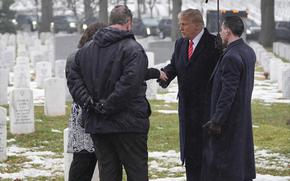 President-elect Donald Trump and Melina Trump talk with family members of Army Staff Sgt. Ryan Christian Knauss, in Section 60 at Arlington National Cemetery, Sunday, Jan. 19, 2025, in Arlington, Va. (AP Photo/Evan Vucci)