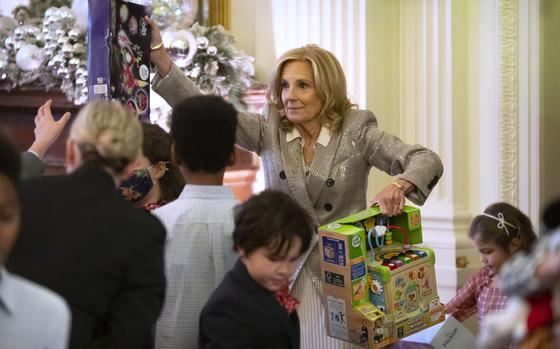 First lady Jill Biden helps to sort toys as she hosts a Toys for Tots event with Marine Corps families in the East Room at the White House in Washington, Friday, Dec. 13, 2024. (AP Photo/Mark Schiefelbein)