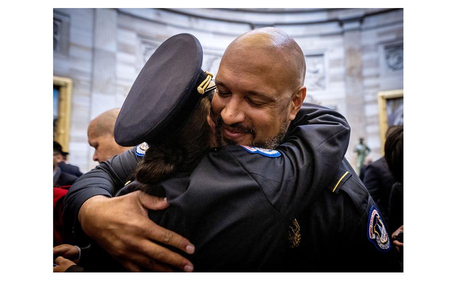 Capitol Police officer Harry Dunn hugs a colleague after a Congressional Gold Medal ceremony in December 2022. 