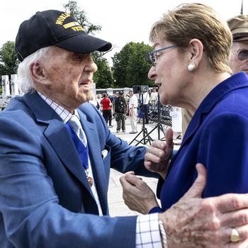 World War II Merchant Marine veteran Dave Yoho hugs Rep. Marcy Kaptur, D-Ohio, before the 20th anniversary celebration of the National World War II Memorial in Washington, May 25, 2024.