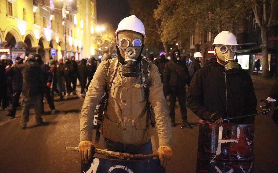 Protesters wear gas masks in Tbilisi, Georgia.