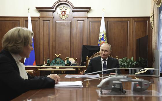 Russian President Vladimir Putin, right, speaks with Anna Popova, the Head of the Federal Service for the Oversight of Consumer Protection and Welfare, during their meeting at the Kremlin in Moscow, Russia, Monday, Sept. 16, 2024. (Alexander Kazakov, Sputnik, Kremlin Pool Photo via AP)