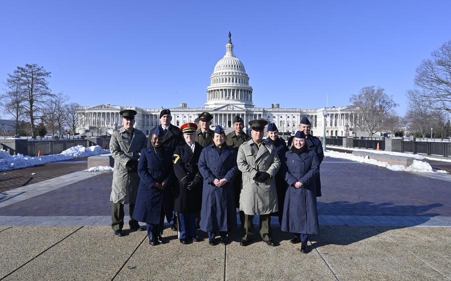 The Capitol rises in the background above a group of service members.