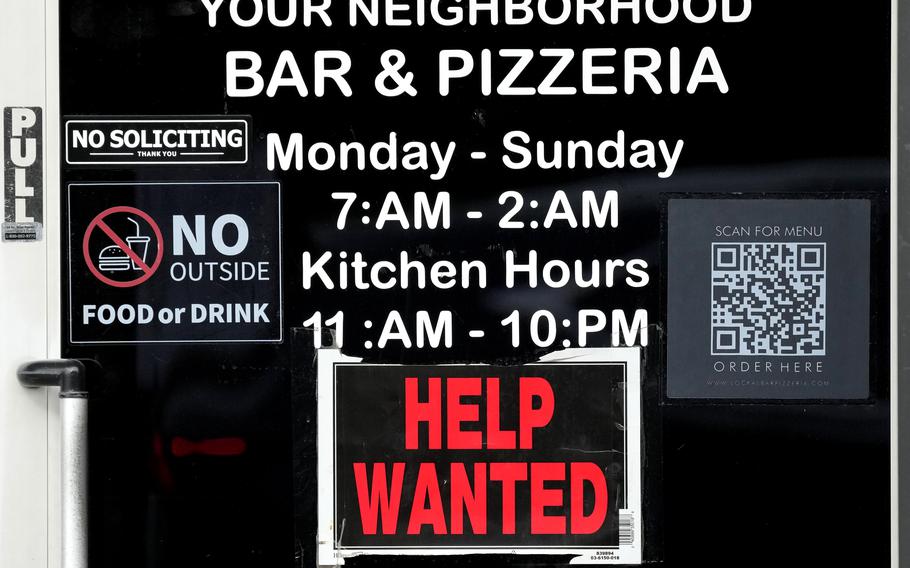 A help wanted sign is displayed at a bar and pizzeria in Chicago on Nov. 25, 2024.