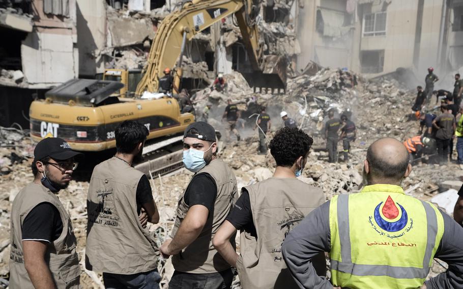 Emergency workers use an excavator to clear the rubble at the site of Friday’s Israeli strike in Beirut’s southern suburbs, Saturday, Sept. 21, 2024. 