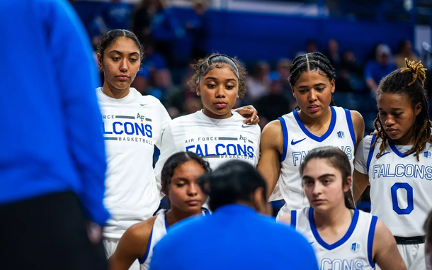 Women on the Air Force basketball team listen to a coach or referee in an undated photo from 2024.