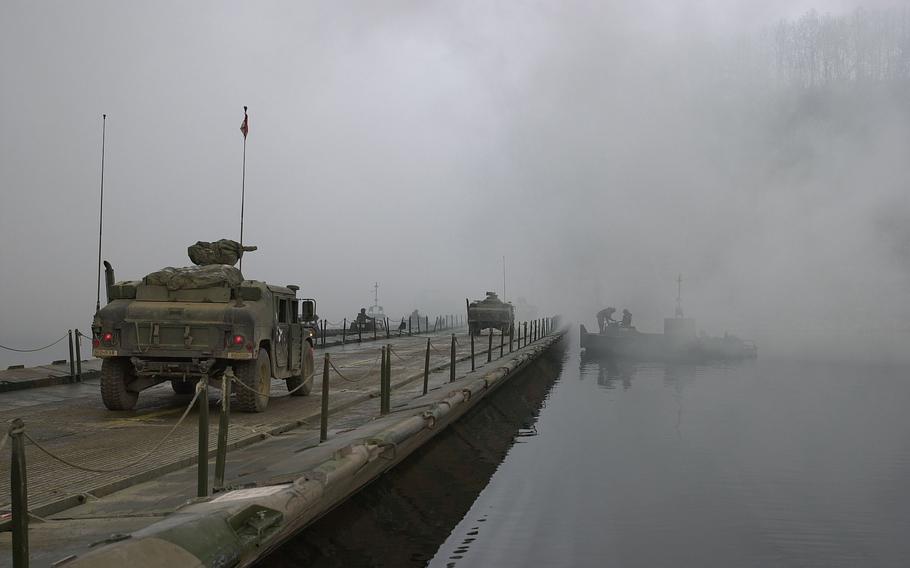 Military vehicles cross the Imjin River