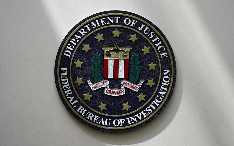 An FBI seal is seen on a wall