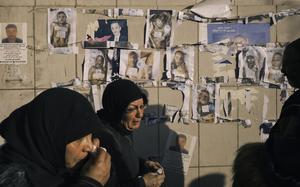 Family members of inmates and people who disappeared during the Assad regime look for the bodies of loved ones inside a morgue in Damascus, Syria. Images of bodies that have been found have been posted on a wall outside the hospital. MUST CREDIT: Lorenzo Tugnoli for The Washington Post