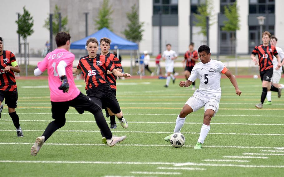 Naples attacker Joaquin Villescas tries to go around American Overseas School of Rome goalkeeper Carson Cicchi during the Division II title match at the DODEA European soccer championships on May 23, 2024, at Ramstein High School on Ramstein Air Base, Germany.