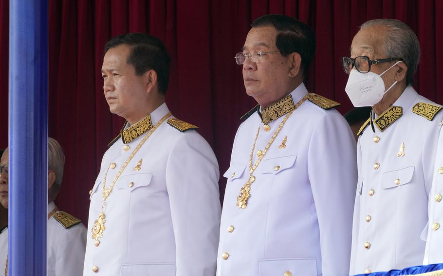 Cambodian Prime Minister Hun Manet stands next to his father and former prime minister Hun Sen in Phnom Penh, Cambodia, Nov. 9, 2023. 