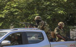 Soldiers patrol amid the sound of gunshots heard in the distance, in Port-au-Prince, Haiti, Thursday, Oct. 17, 2024. (AP Photo/Odelyn Joseph)