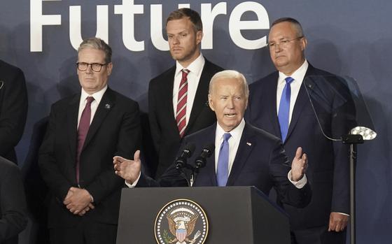 FILE - Britain's Prime Minister Keir Starmer, left, looks on as U.S. President Joe Biden speaks, where he introduced Ukrainian President Volodymyr Zelenskyy during an event on the Ukraine Compact at the NATO Summit at the Walter E. Washington Convention Center, in Washington, Thursday, July 11, 2024. Biden's withdrawal from the U.S. presidential race injects greater uncertainty into the world. (Stefan Rousseau/Pool Photo via AP, File)