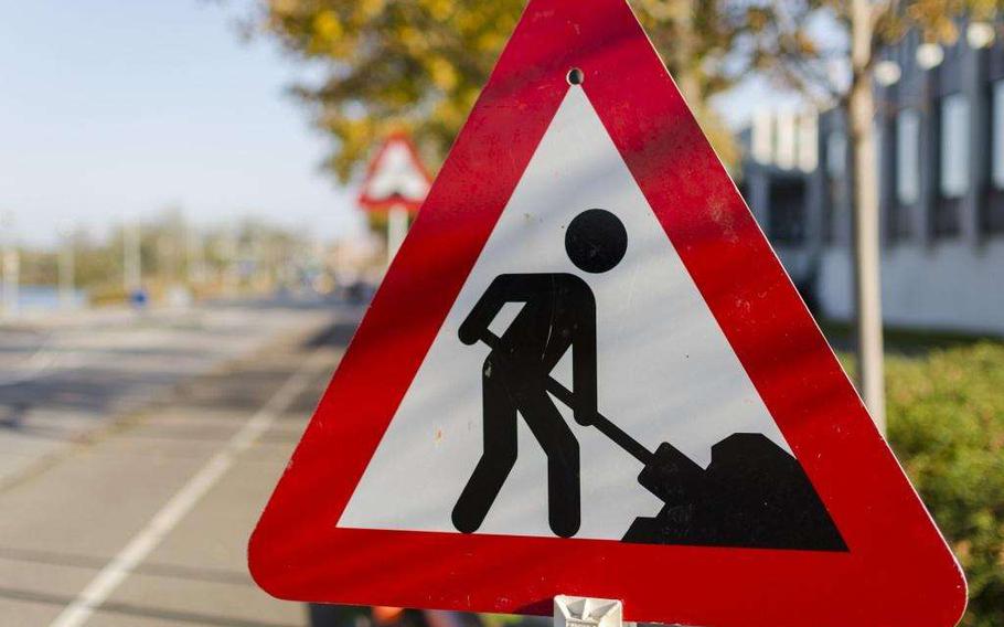 A road sign that shows a stick figure digging.