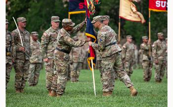 Maj. Gen. Monté  L. Rone receives the 1st Infantry Division colors from Lt. Gen. Sean C. Bernabe, III Armored Corps Commander, on Cavalry Parade Field, Fort Riley, Kansas June 28, 2024. 