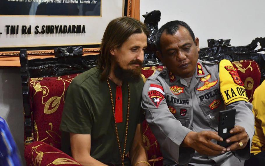 In this photo released by Cartenz Peace Task Force (Satgas Damai Cartenz) of the Indonesian security forces, New Zealand pilot Phillip Mehrtens, left, who was held hostage for more than a year in the restive Papua region.