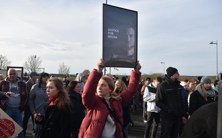 A person holds a sign as she protests outside a U.S. Air Force base in Germany.