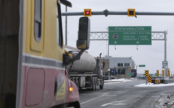 Trucks head toward the US at the border in St-Bernard-de-Lacolle, Quebec. MUST CREDIT: Christinne Muschi/Bloomberg