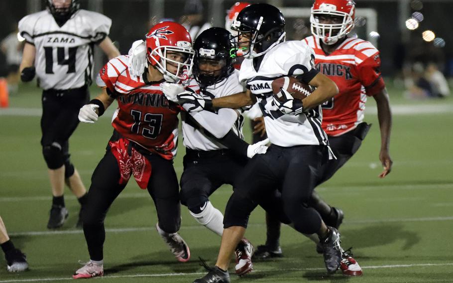 Zama's Andrew Byrd looks for running room against Nile C. Kinnick's Joseph Mauldin.