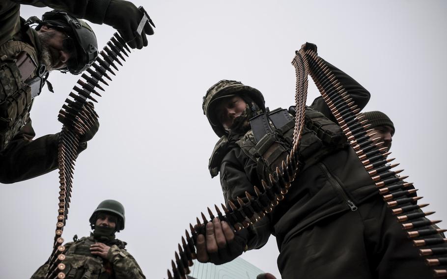 Ukrainian soldiers handle ammunition belts at a training field, Nov. 29, 2024.