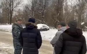 In this photo released Saturday, Dec. 21, 2024, by the official Telegram channel of the Kazan City Hall, local officials look at a damage site at the residential complex called "Lazurnye Nebesa," or Azure Skies, in Kazan, Russia, following Ukrainian drone attacks. (Official Telegram channel of the Kazan City Hall via AP)